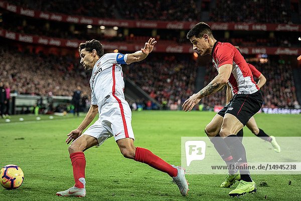 Jesus Navas (L) and Yuri Berchiche (R) dispute the ball during a Spanish League match between Athletic Club Bilbao and Sevilla FC at San Mames Stadium on January 13  2019 in Bilbao  Spain