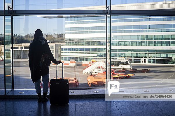 A woman waits at the airport.