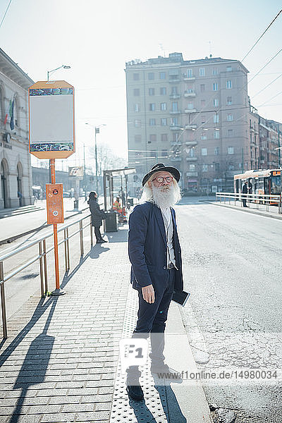 Senior businessman waiting at bus stop  Milano  Lombardia  Italy