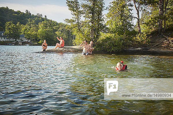Family swimming in lake