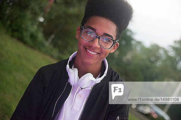 Teenage boy with afro flat top hairstyle in park   portrait