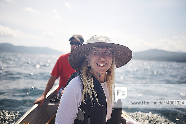 Smiling woman and friend in canoe