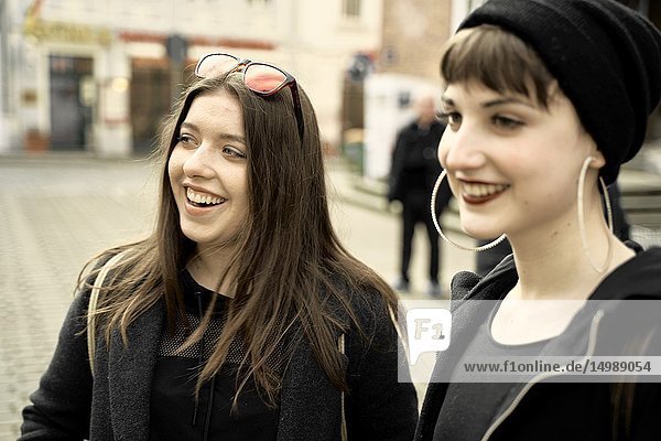 Two women smiling at street  in city Cottbus  Brandenburg  Germany.