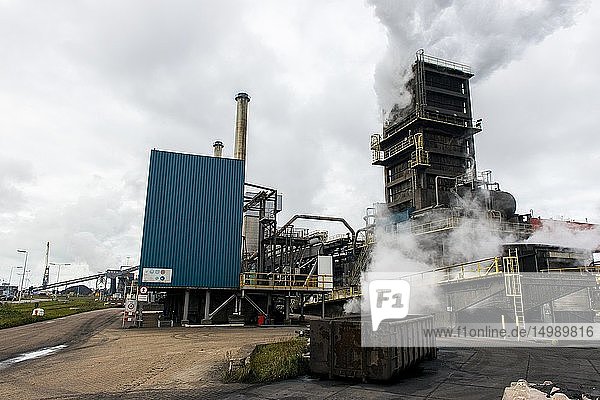 IJmuiden Netherlands. Huge heavy steel production plant and industry terrain producing various kinds of steel inside an CO2 emitting factory. The steel plant is called Hoogovens and is owned by Tata Steel an international corporation who also suffers from decline in revenues and ever increasing demands on corporate responsibility regarding labour and climate.