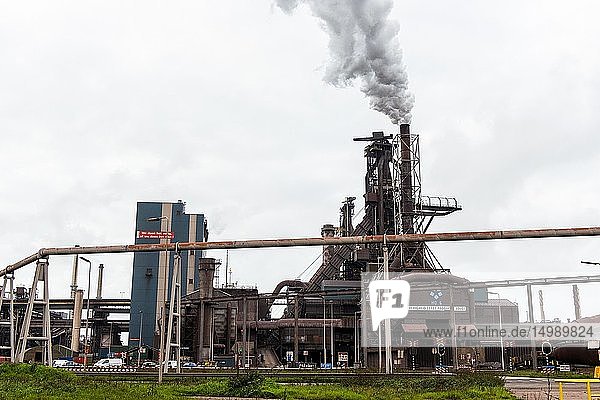 IJmuiden Netherlands. Huge heavy steel production plant and industry terrain producing various kinds of steel inside an CO2 emitting factory. The steel plant is called Hoogovens and is owned by Tata Steel an international corporation who also suffers from decline in revenues and ever increasing demands on corporate responsibility regarding labour and climate.