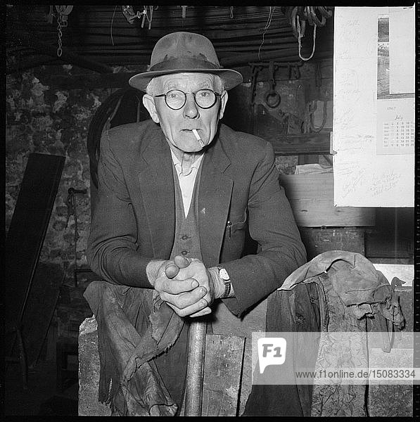 Elderly man posed in a workshop  1967. Creator: Eileen Deste.
