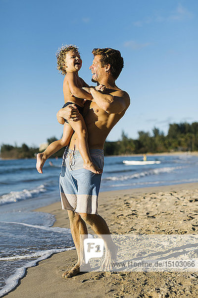 Man playing with his son on beach