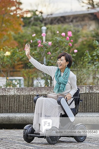 Japanese senior woman on electric wheelchair