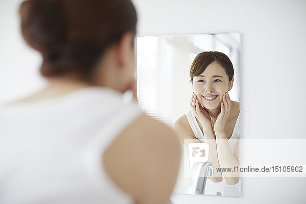 Young Japanese woman at home getting ready in the morning