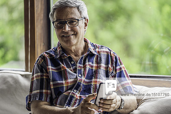 Porträt eines reifen Mannes mit Smartphone