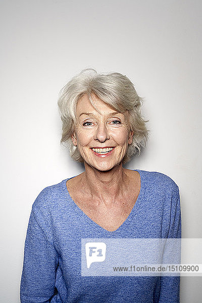 Portrait of smiling mature woman wearing blue pullover