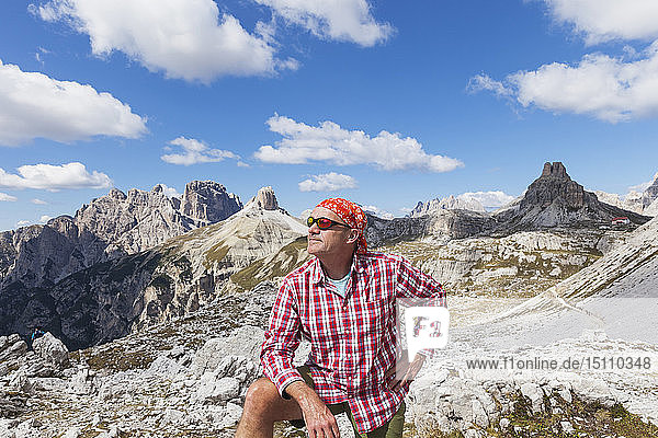 Hiker looking at view  Tre Cime di Lavaredo Aera  Nature Park Tre Cime  Unesco World Heritage Natural Site  Sexten Dolomites  Italy