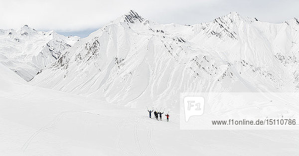 Georgia  Caucasus  Gudauri  group of people cheering on a ski tour