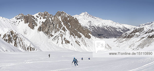 Georgia  Caucasus  Gudauri  people on a ski tour riding downhill