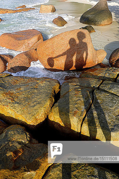 Seychelles  Praslin  Anse Lazio  shadows of couple on rocks at seashore
