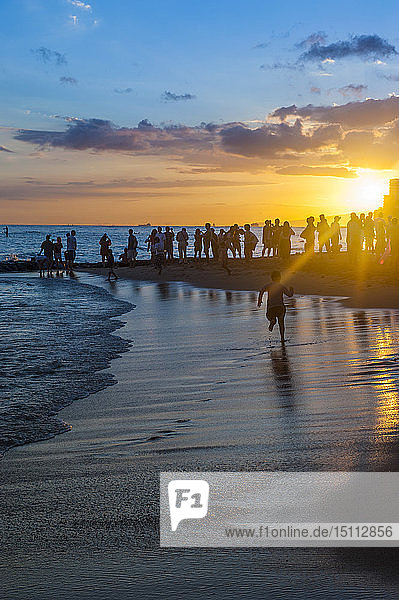 Hawaii  Oahu  Strand von Waikiki  Touristen  die den Sonnenuntergang beobachten