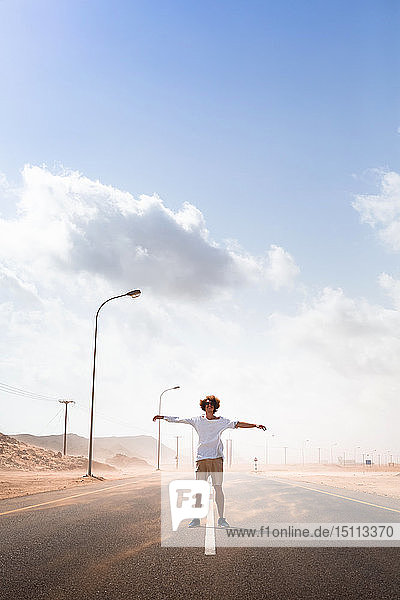 Sultanate Of Oman Ras al Hadd Desert road Man standing in a sand storm