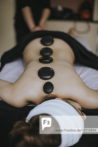 Woman laying on stomach enjoying a spa treatment on her back