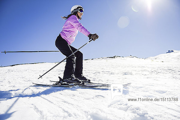 Woman skiing under blue sky  Sierra Nevada  Andalusia  Spain