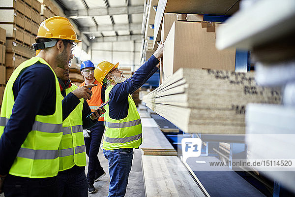 Men working in factory warehouse