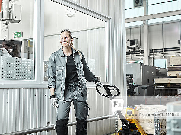 Industry woman using pallet jack