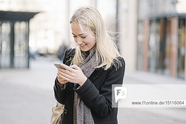 Young woman using cell phone in the city