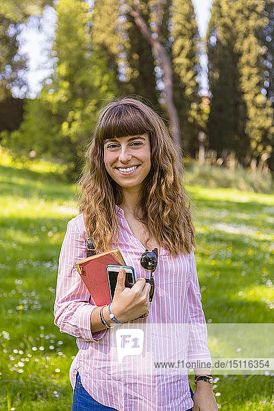 Young woman on a city break  holding guidebook