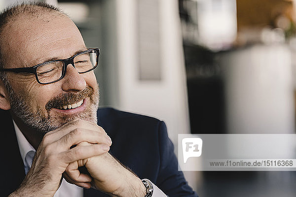 Portrait of happy mature businessman in a cafe