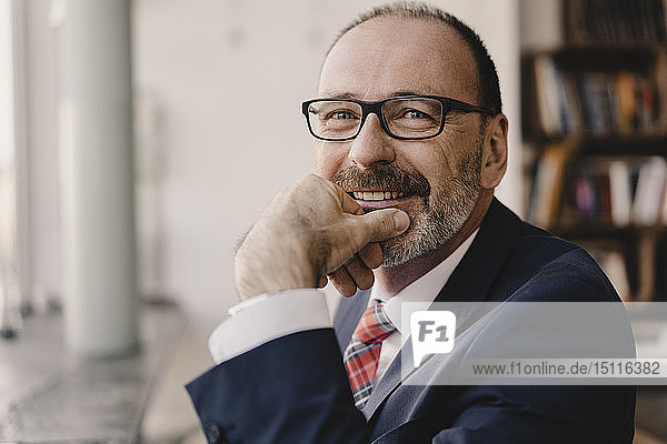 Portrait of smiling mature businessman in a cafe