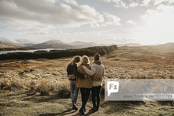 UK  Scotland  Loch Lomond and the Trossachs National Park  rear view of female friends looking at view