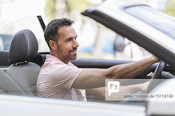 Portrait of man driving convertible