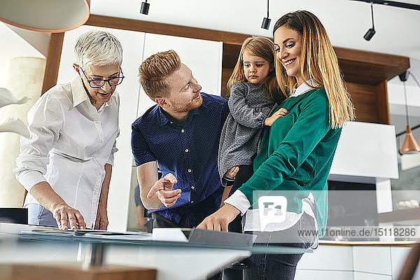 Family shopping for a new kitchen in showroom