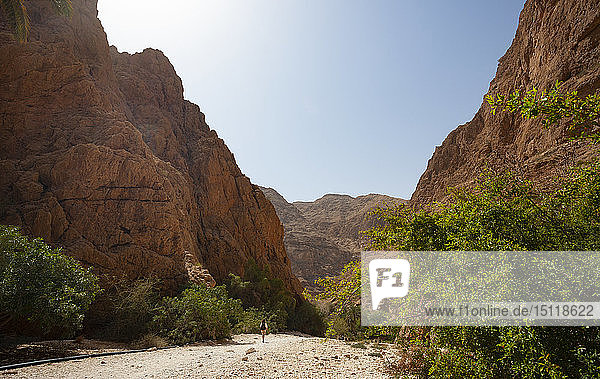 Man walking through rocks  Wadi Shab  Oman