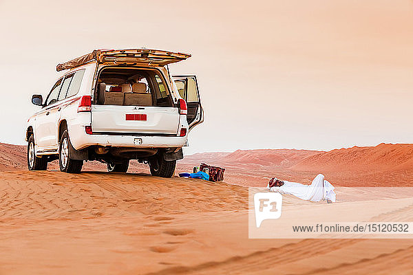 Beduine bei einer Pause neben seinem Auto in der Wüste  Wahiba Sands  Oman