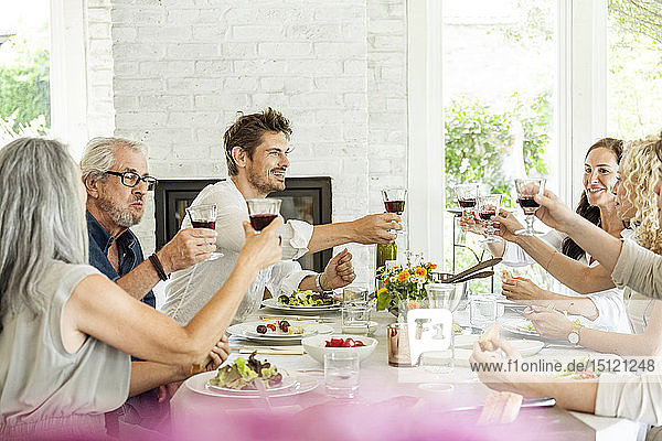 HapÃ¼py family celebrating together  clinking glasses