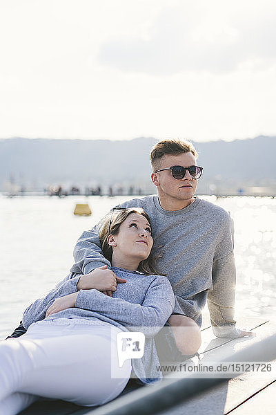 Young couple relaxing on jetty at Lake Zurich  Zurich  Switzerland