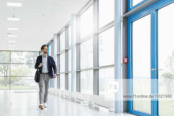 Young businessman walking in a passageway