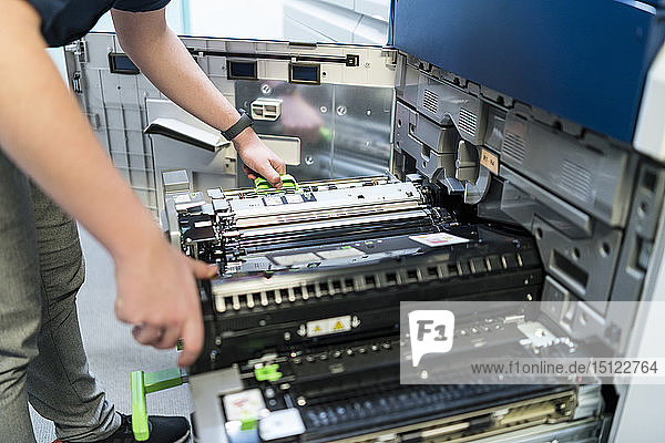 Close-up of teenager working at color printer