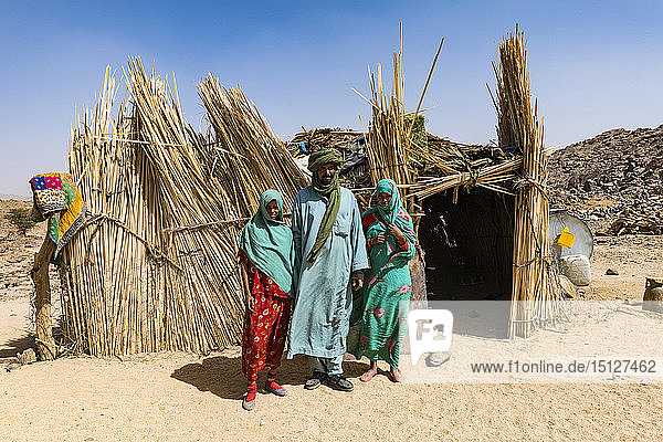 Tuareg family posing in front of their hut near Tamanrasset Algeria North Africa Africa