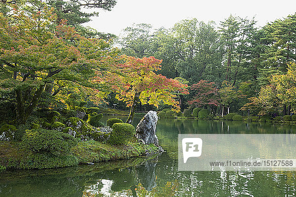 Autumn foliage on Horajima Island in Kasumi Pond in the Kenrokuen Garden Kanazawa Ishigawa Japan Asia