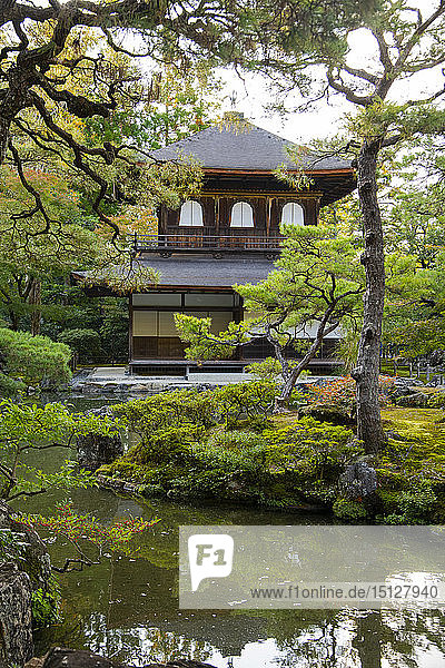 The Silver Pavilion reflected in a pond surrounded by pine trees at the Ginkaku-ji Pure Land Garden Kyoto Japan Asia