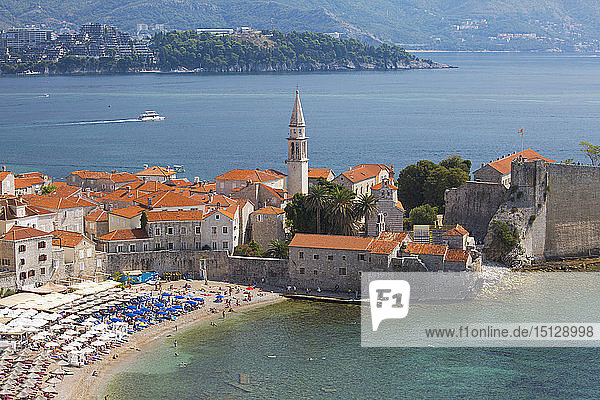 View over crowded beach to the Old Town (Stari Grad)  and Budva Bay  Budva  Montenegro  Europe