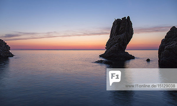 View from Calura Bay across the Tyrrhenian Sea  dawn  rock stack silhouetted against red sky  Cefalu  Palermo  Sicily  Italy  Mediterranean  Europe