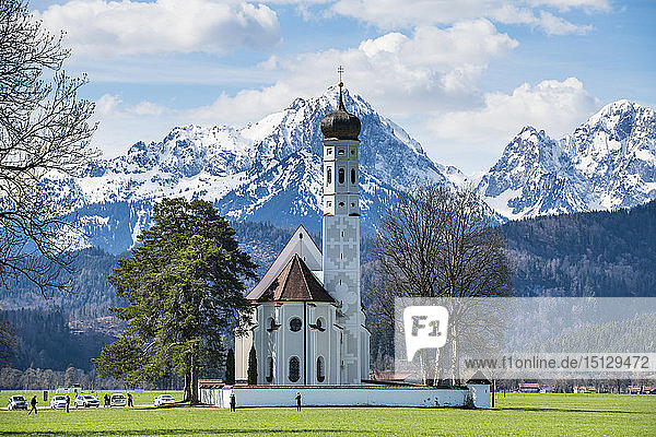 Catholic Church of St. Coloman with the Alps behind Schwangau Bavaria Germany Europe