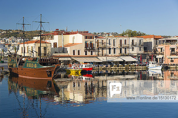 View across the Venetian Harbour  quayside buildings reflected in still water  Rethymno (Rethymnon)  Crete  Greek Islands  Greece  Europe