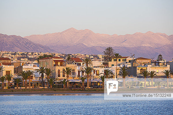View to the waterfront and distant peaks of the Lefka Ori  sunrise  Rethymno (Rethymnon)  Crete  Greek Islands  Greece  Europe