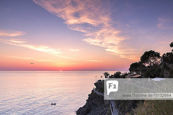 Sunset on the sea above the panoramic footpath of Manarola Cinque Terre UNESCO World Heritage Site Liguria Italy Europe