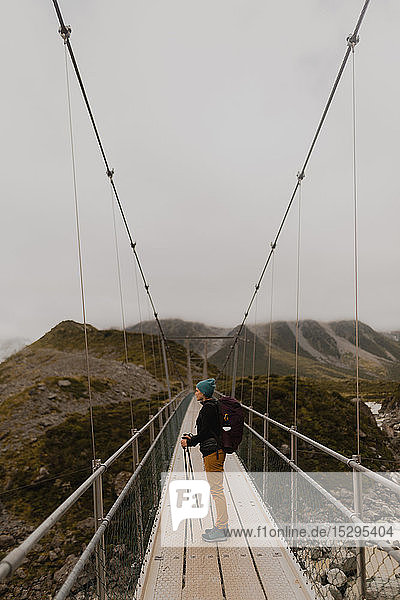 Hiker enjoying view on suspension bridge  Wanaka  Taranaki  New Zealand