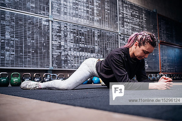 Young woman stretching in gym