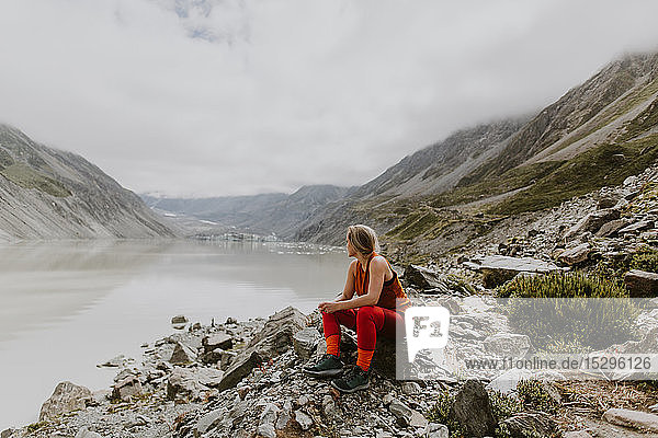 Woman enjoying scenic view by lake  Wanaka  Taranaki  New Zealand
